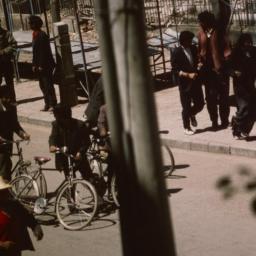 Tibetan men riding bicycles...