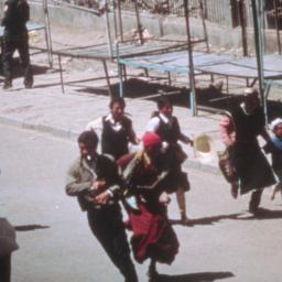 Tibetans running past deser...