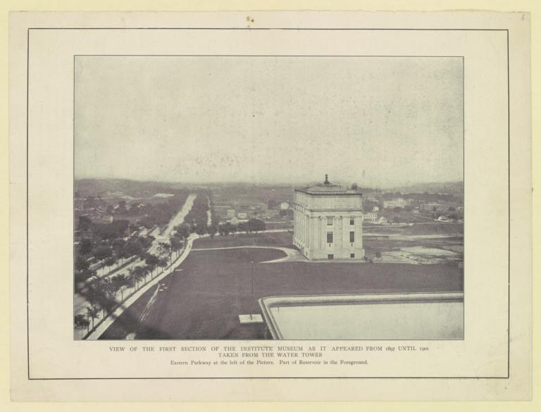 View of the first section of the Institute Museum as it appeared from 1897 until 1901 taken from the water tower. Eastern Parkway at the left of the Picture. Part of Reservoir in the Foreground
