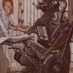 Two men working with printi...
