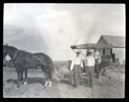 Horse and Buggy with Several People Standing around It