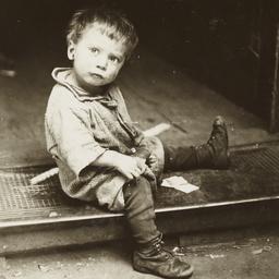Boy Sitting on Grate