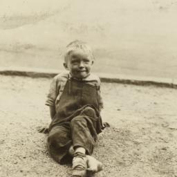 Boy Sitting on Dirt