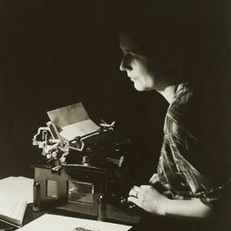 Woman at Typewriter in Dark...