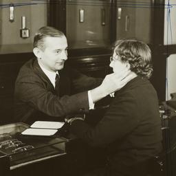 Man Fitting Woman for Eyegl...
