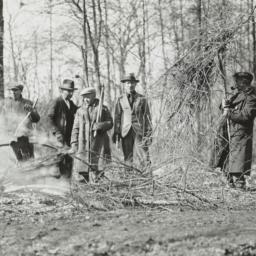 Men Burning Tree Limbs